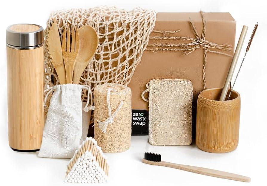 Assortment of eco-friendly products including reusable utensils, containers, and bamboo toothbrush on a white background.