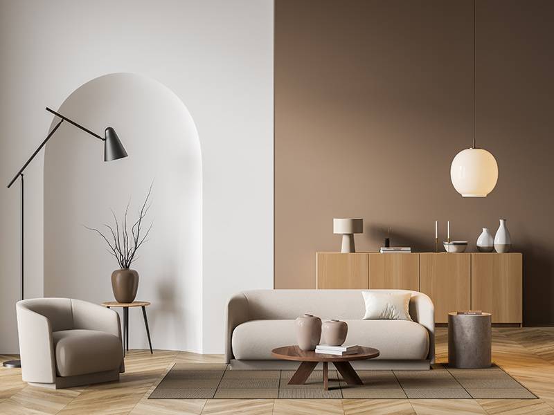  Modern living room interior with neutral tones, featuring a sofa, armchair, and minimalist decor.