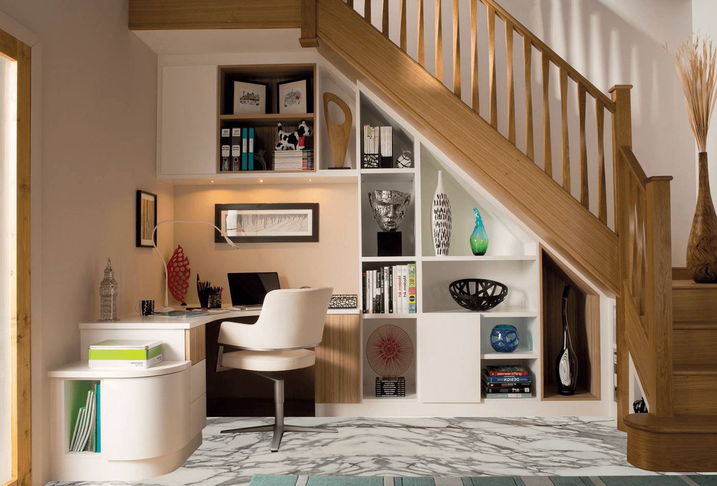  Under-stair creatively transformed into a compact office with built-in shelves, a desk, and decorative items.
