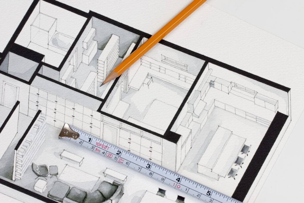 Architectural blueprint of a building layout, with pencil, ruler, and eraser on white paper.