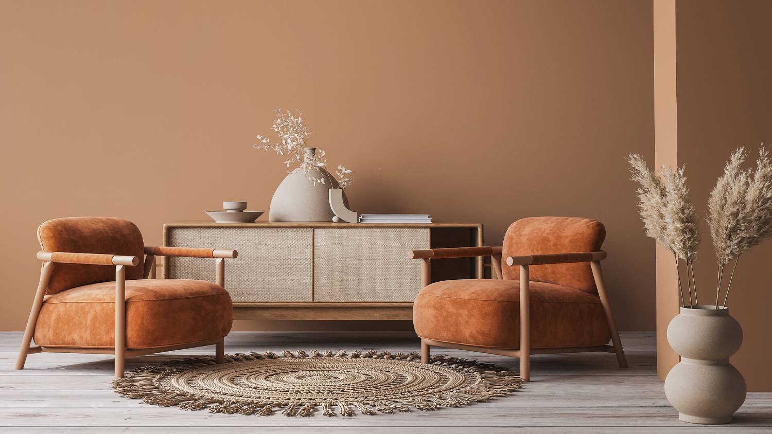 A minimalist living room with two velvet armchairs, a console table, decorative vases, and a circular rug.